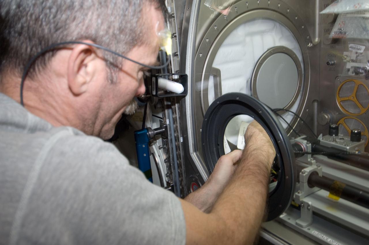 ISS034-E-010632 (31 Dec. 2012) --- Canadian Space Agency astronaut Chris Hadfield, Expedition 34 flight engineer, works with the InSpace-3 investigation in the Microgravity Science Glovebox (MSG) in the Destiny laboratory of the International Space Station.