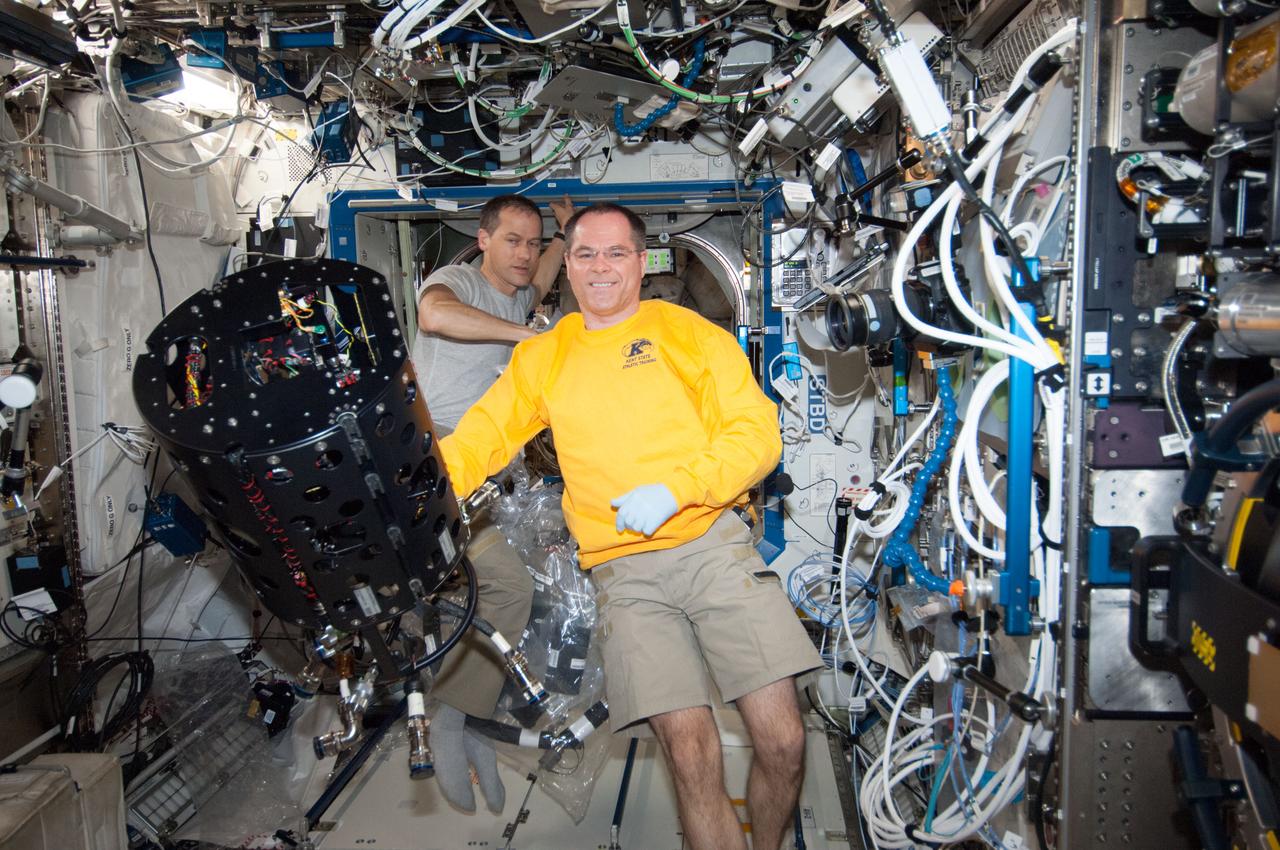 ISS034-E-023541 (9 Jan. 2013) --- NASA astronauts Kevin Ford (foreground), Expedition 34 commander; and Tom Marshburn, flight engineer, work with the Combustion Integrated Rack (CIR) Multi-user Droplet Combustion Apparatus (MDCA) in the International Space Station's Destiny laboratory.