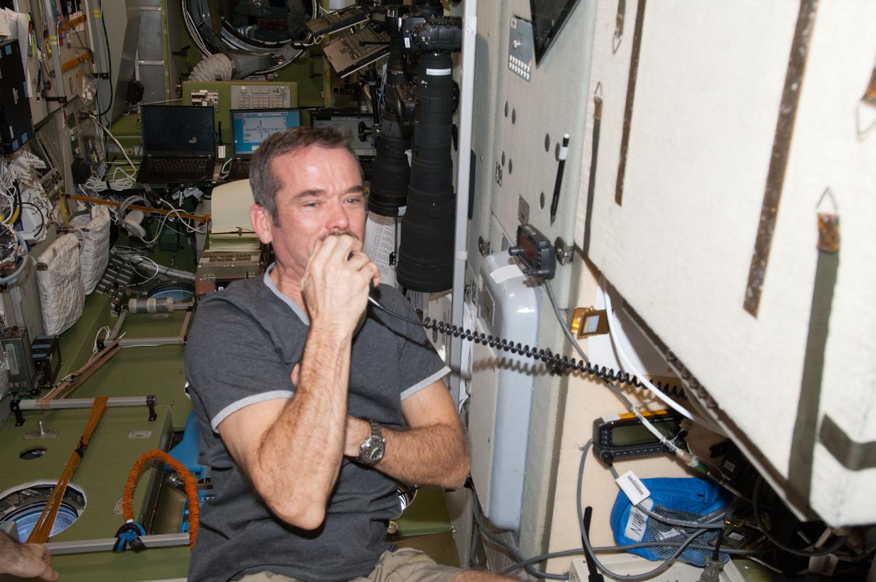 ISS034-E-023688 (5 Jan. 2013) --- Canadian Space Agency astronaut Chris Hadfield, Expedition 34 flight engineer, conducts a ham radio session in the Zvezda Service Module of the International Space Station.