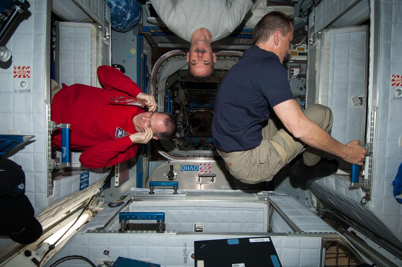 ISS034-E-026596 (22 Dec. 2012) --- NASA astronaut Kevin Ford (left), Expedition 34 commander; along with Canadian Space Agency astronaut Chris Hadfield (center) and NASA astronaut Tom Marshburn, both flight engineers, are pictured in the Harmony node of the International Space Station.