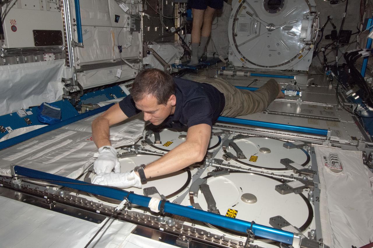 ISS034-E-026607 (7 Jan. 2013) --- NASA astronaut Tom Marshburn, Expedition 34 flight engineer, prepares to insert biological samples in the Minus Eighty Laboratory Freezer for ISS (MELFI-1) in the Kibo laboratory of the International Space Station.