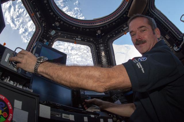 NASA image: Hadfield works robotic controls in the Cupola Module