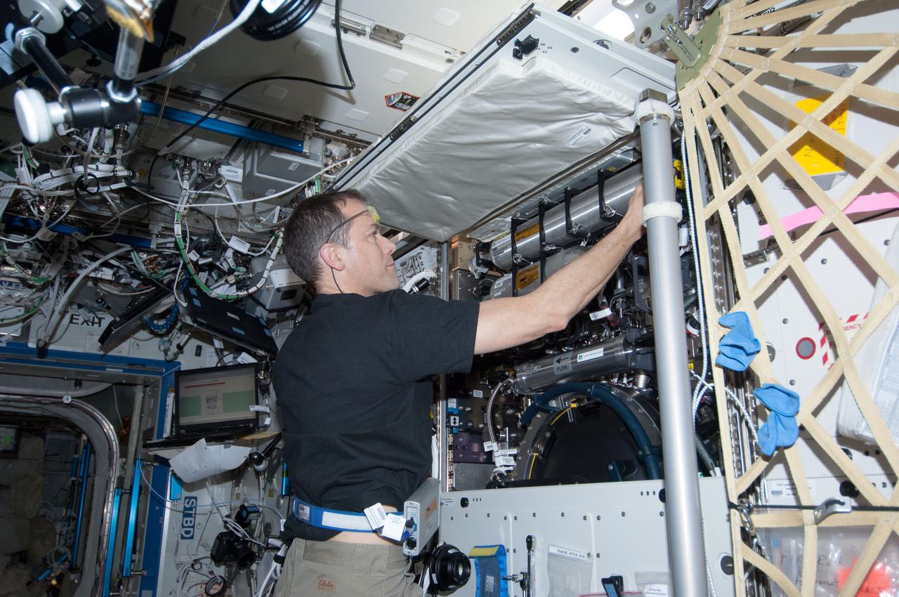 ISS034-E-029873 (15 Jan. 2013) --- NASA astronaut Tom Marshburn, Expedition 34 flight engineer, services the Combustion Integrated Rack (CIR) in the Destiny laboratory of the International Space Station.