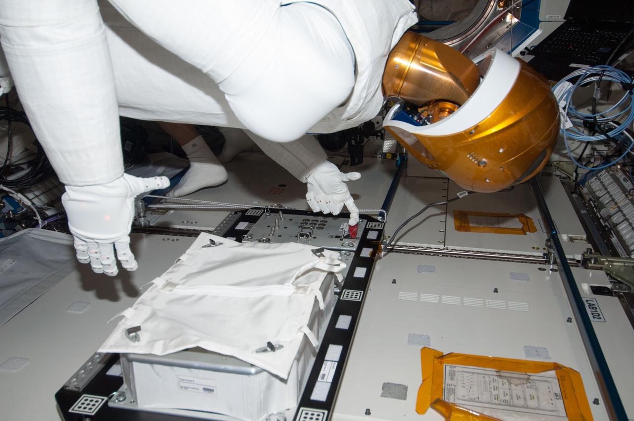 ISS034-E-031124 (17 Jan. 2013) --- In the International Space Station's Destiny laboratory, Robonaut 2 is pictured during a round of testing for the first humanoid robot in space. Ground teams put Robonaut through its paces as they remotely commanded it to operate valves on a task board. Robonaut is a testbed for exploring new robotic capabilities in space, and its form and dexterity allow it to use the same tools and control panels as its human counterparts do aboard the station.