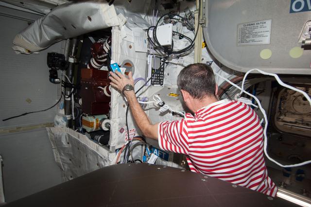 NASA image: Hadfield removes the WTSM and installs the WOOV in the Columbus Module
