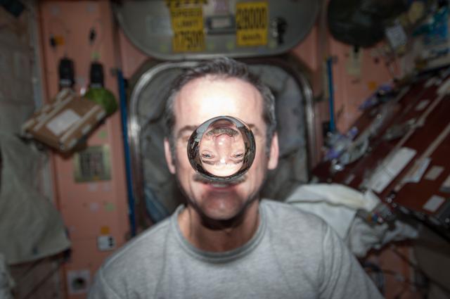 NASA image: Hadfield watches a water bubble float freely in the Node 1