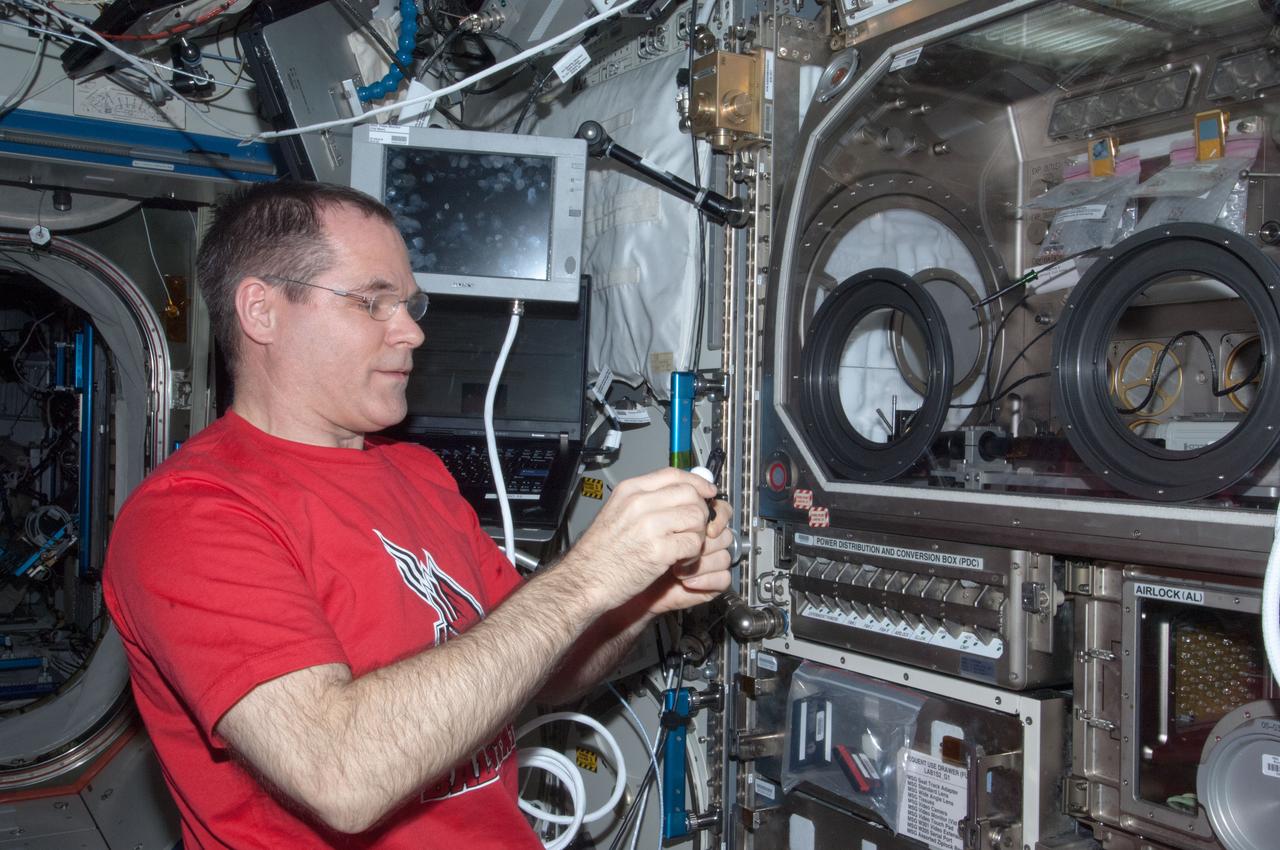 ISS034-E-033733 (24 Jan. 2013) --- NASA astronaut Kevin Ford, Expedition 34 commander, works with the InSPACE-3 hardware inside the Microgravity Science Glovebox (MSG) in the Destiny laboratory of the International Space Station. InSPACE-3 applies different magnetic fields to vials of colloids, or liquids with microscopic particles, and observes how fluids can behave like a solid. Results may improve the strength and design of materials for stronger buildings and bridges.