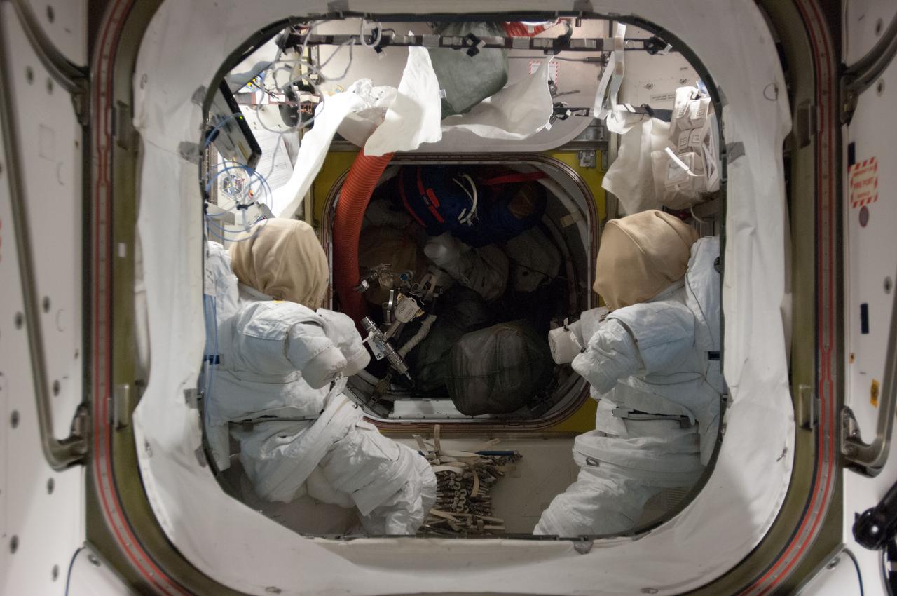 View of stowed Extravehicular Mobility Units (EMUs),in the Airlock (A/L).  Photo was taken during Expedition 34.