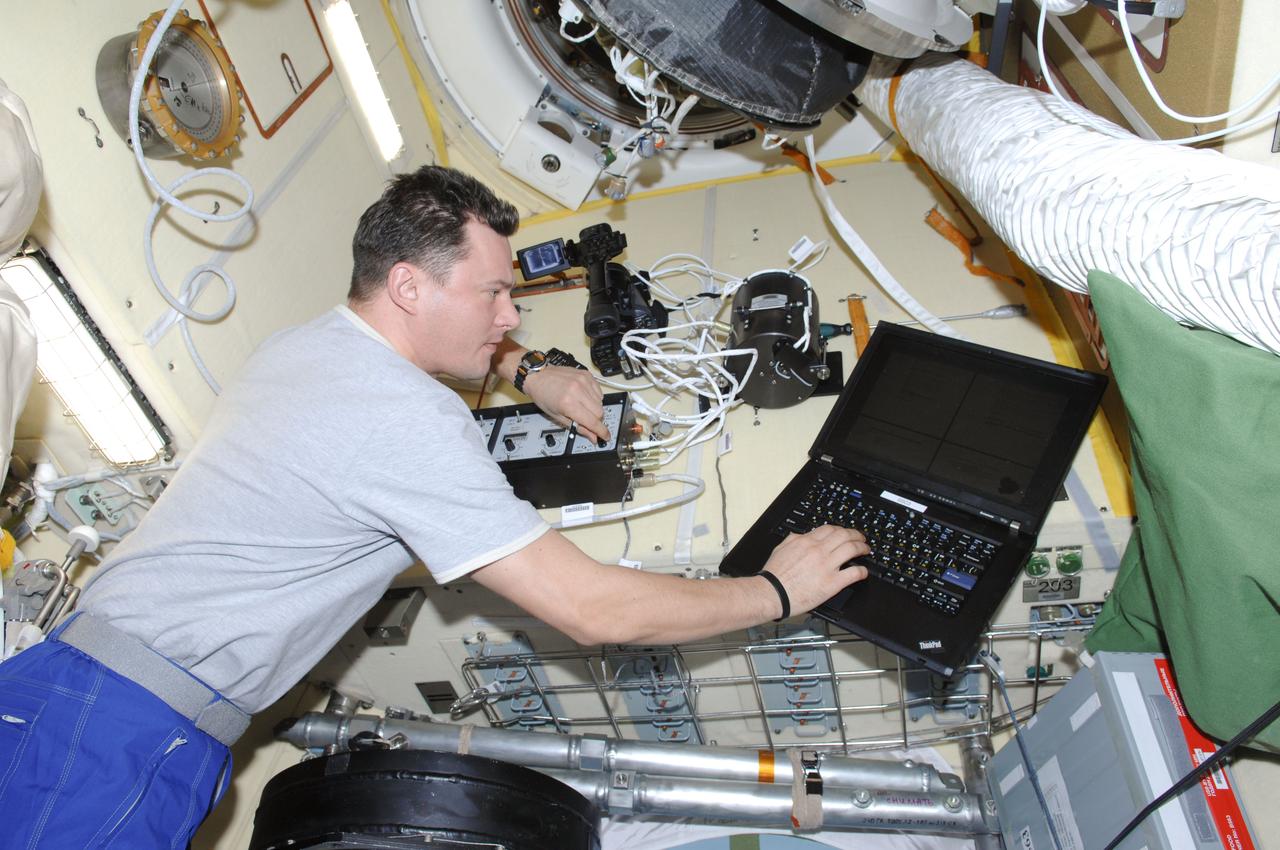 ISS034-E-035764 (28 Jan. 2013) --- In the International Space Station?s Poisk Mini-Research Module 2 (MRM2), Russian cosmonaut Roman Romanenko, Expedition 34 flight engineer, works with the Coulomb Crystal experiment, which gathers data about charged particles in a weightless environment.