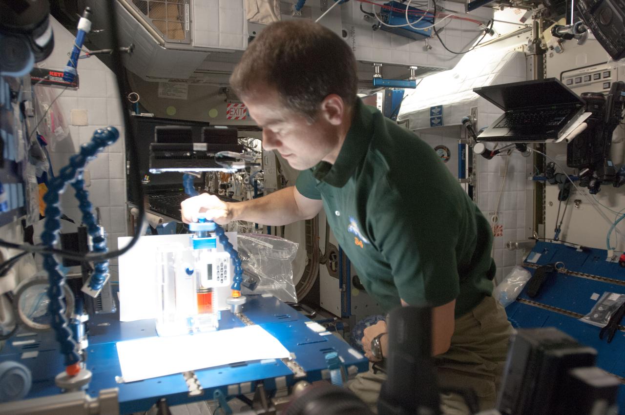ISS034-E-036841 (29 Jan. 2013) --- In the International Space Station’s Harmony node, NASA astronaut Tom Marshburn, Expedition 34 flight engineer, works with the Capillary Flow Experiment-3, which investigates how fluids flow across surfaces in a weightless environment. Results from this experiment will improve computer models used to design fluid transfer systems and fuel tanks on future spacecraft.