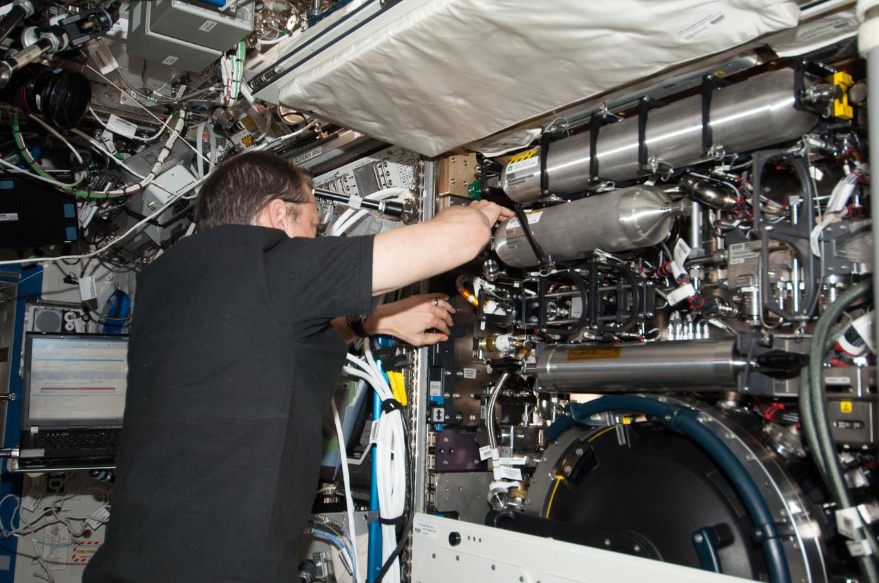 ISS034-E-037331 (31 Jan. 2013) --- NASA astronaut Tom Marshburn, Expedition 34 flight engineer, services the Combustion Integrated Rack (CIR) in the Destiny laboratory of the International Space Station.