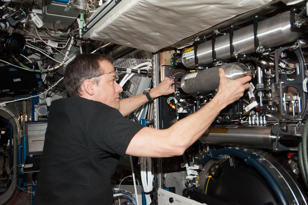 ISS034-E-037334 (31 Jan. 2013) --- NASA astronaut Tom Marshburn, Expedition 34 flight engineer, services the Combustion Integrated Rack (CIR) in the Destiny laboratory of the International Space Station.