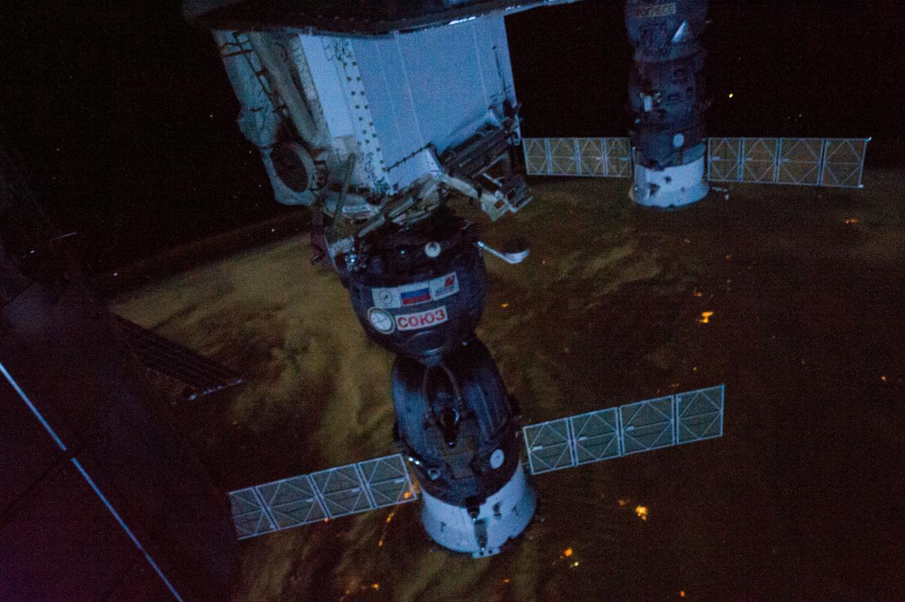 ISS034-E-039039 (1 Feb. 2013) --- The International Space Station was flying over  northern China about 500 miles southwest of Beijing when one of the Expedition 32 crew members photographed this interesting night view. Local time was nearly 4 a.m., which means this panoramic view is looking away from daybreak. Two Russian spacecraft -- a Soyuz (center frame) and a Progress -- dominate the foreground. The Soyuz is docked to the Mini-Research Module 1 (MRM-1).  The Permanent Multipurpose Module (PMM) is also visible (silhouette at left edge).