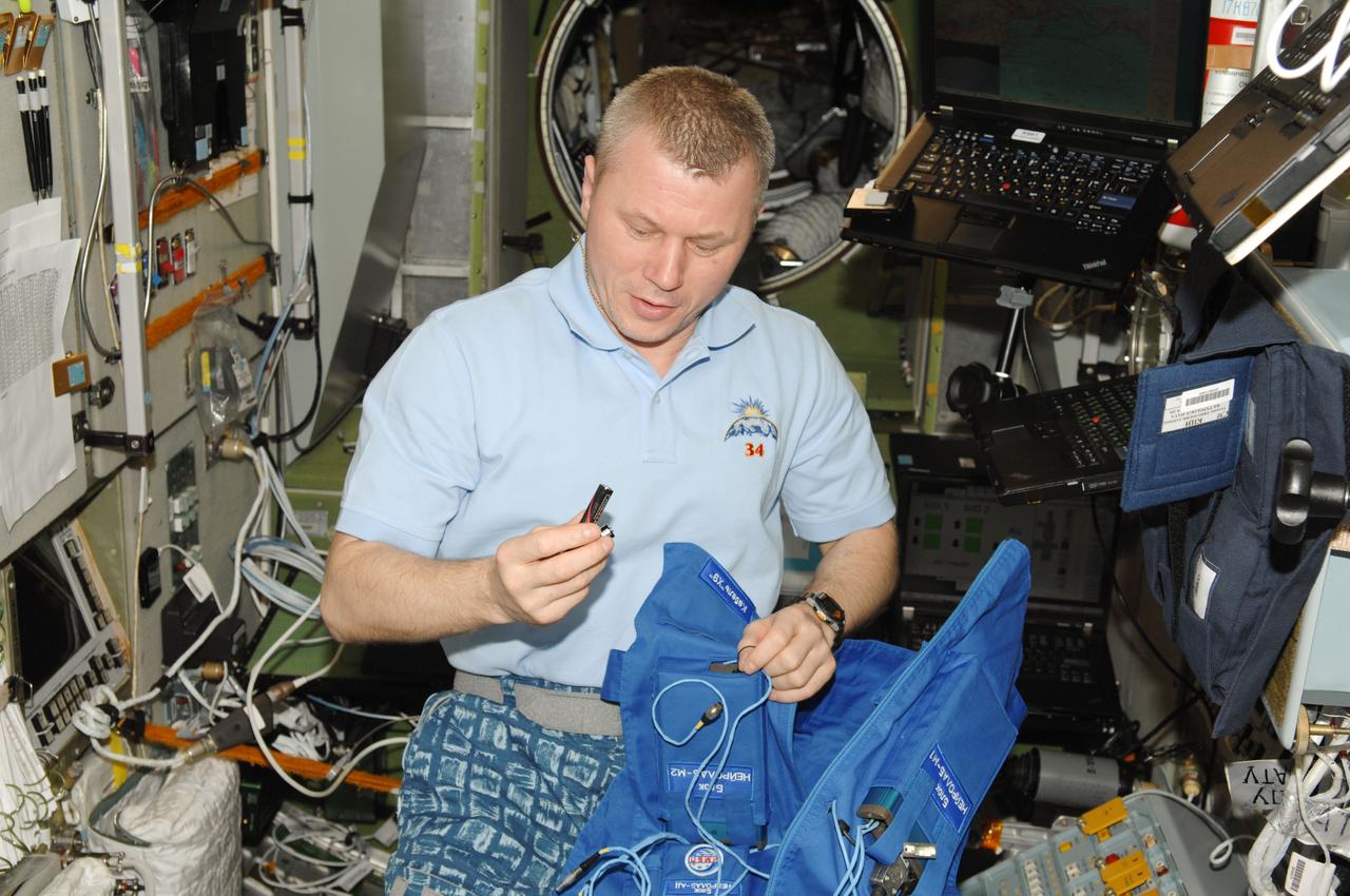 ISS034-E-042297 (12 Feb. 2013) --- Russian cosmonaut Oleg Novitskiy, Expedition 34 flight engineer, prepares for the Typologia experiment in the Zvezda Service Module of the International Space Station. This experiment studies the crew member's psychophysical state and ability to perform and communicate under stress.