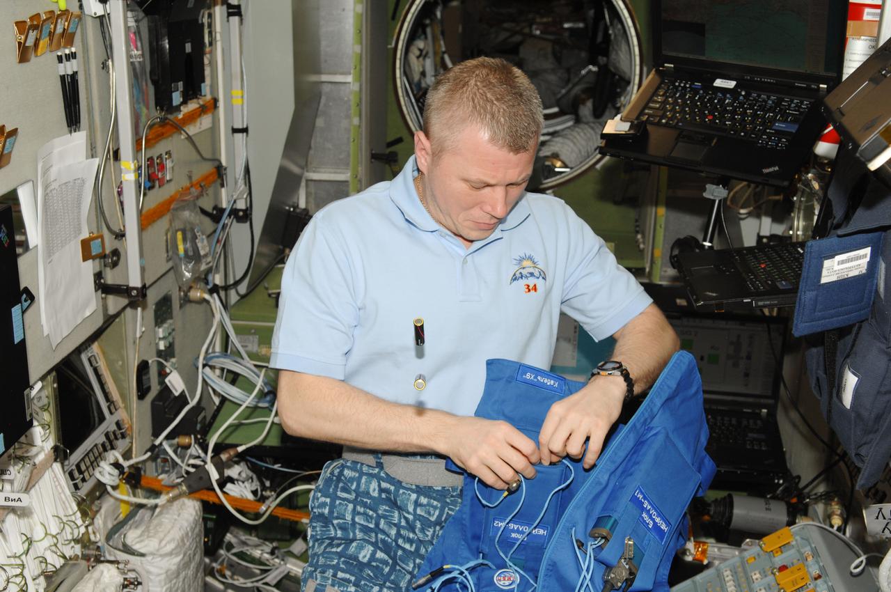 ISS034-E-042298 (12 Feb. 2013) --- Russian cosmonaut Oleg Novitskiy, Expedition 34 flight engineer, prepares for the Typologia experiment in the Zvezda Service Module of the International Space Station. This experiment studies the crew member's psychophysical state and ability to perform and communicate under stress.