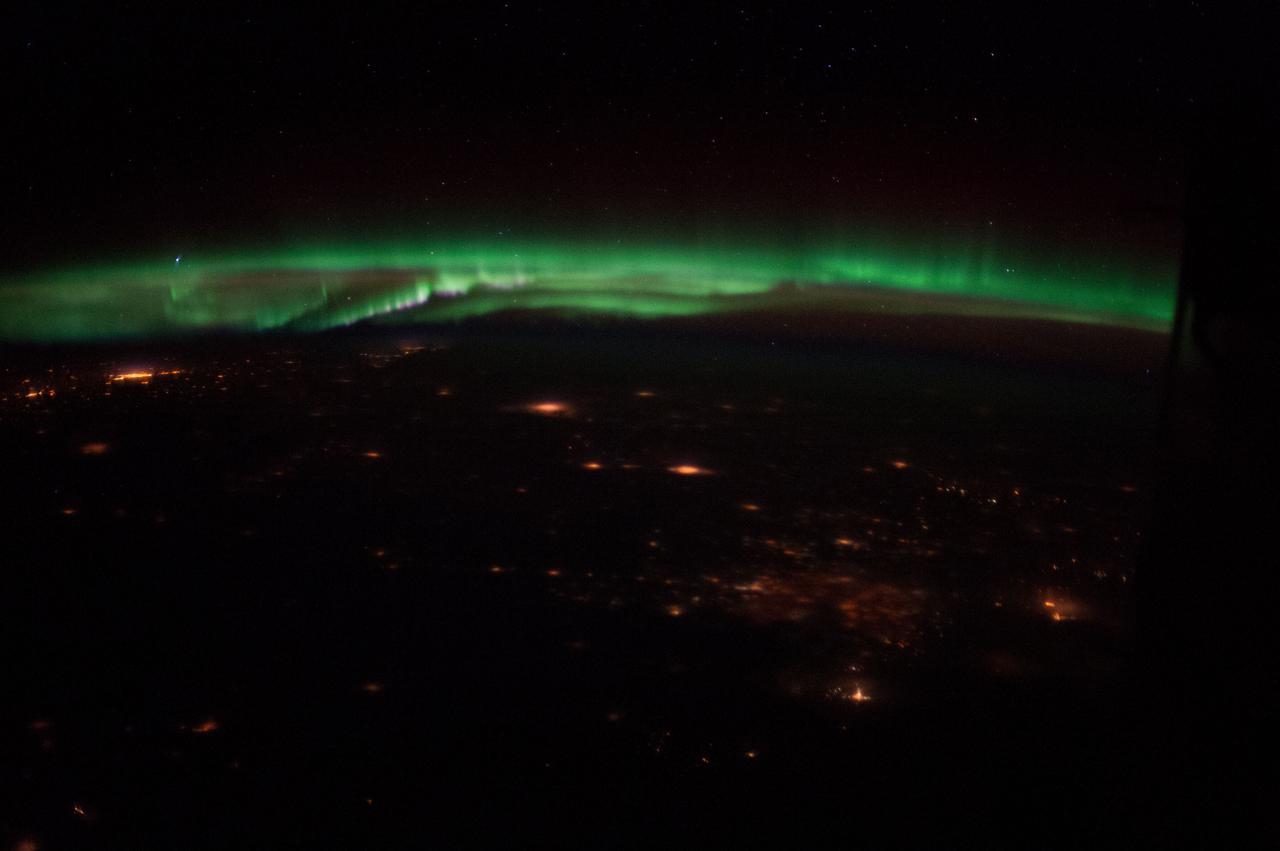 ISS034-E-045223 (10 Feb. 2013) -- One of the Expedition 34 crew members aboard the International Space Station captured this night panorama featuring a display of Northern Lights, also known as Aurora Borealis, and scattered lights in the more highly populated areas in the state of Colorado and possibly the states north of it. A 50 millimeter lens was used to record the image.