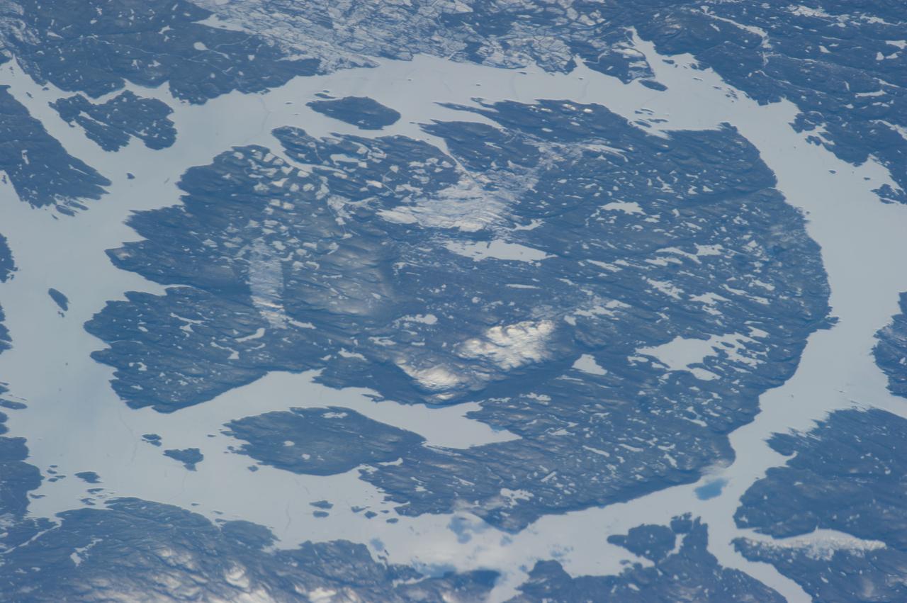 ISS034-E-056100 (21 Feb. 2013) --- One of the most recognizable natural features on Earth, when viewing from space, is the Manicouagan Crater, one of the oldest known impact craters on Earth. Photographed by one of the Expedition 34 crew members onboard the International Space Station, the crater is located primarily in Manicouagan Regional County Municipality in the Côte-Nord region of Québec, Canada, about 300 kilometers (190 miles) north of the city of Baie-Comeau. Manicouagan is one of the oldest large astroblemes still visible on the surface. The crater is a multiple-ring structure about 100 kilometers (60 miles) across, with its 70 kilometer (40 mile) diameter inner ring its most prominent feature; it contains a 70 kilometer (40 mile) diameter annular lake, the Manicouagan Reservoir, surrounding an inner island plateau.