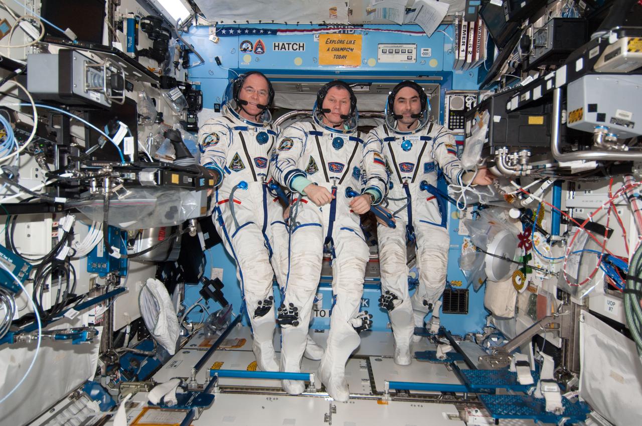 ISS034-E-061654 (5 March 2013) --- With their scheduled stay onboard the International Space Station headed toward its final days, three members of the Expedition 34 crew pose for some  photographs in their Sokol suits in the U.S. lab or Destiny. From left are NASA astronaut Kevin Ford, commander; with Roscosmos Flight Engineers Oleg Novitskiy and Evgeny Tarelkin.  Two days earlier, the trio joined crew members from Russia, the U.S. and Canada in welcoming the arrival of fresh food and supplies aboard the SpaceX Dragon spacecraft.