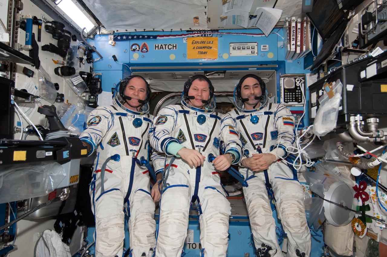 ISS034-E-061655 (5 March 2013) --- With their scheduled stay onboard the International Space Station headed toward its final days, three members of the Expedition 34 crew pose for some  photographs in their Sokol suits in the U.S. lab or Destiny. From left are NASA astronaut Kevin Ford, commander; with Roscosmos Flight Engineers Oleg Novitskiy and Evgeny Tarelkin.  Two days earlier, the trio joined crew members from Russia, the U.S. and Canada in welcoming the arrival of fresh food and supplies aboard the SpaceX Dragon spacecraft.