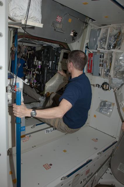 NASA image: Marshburn and Ford move CDRA through U.S. Laboratory hatch