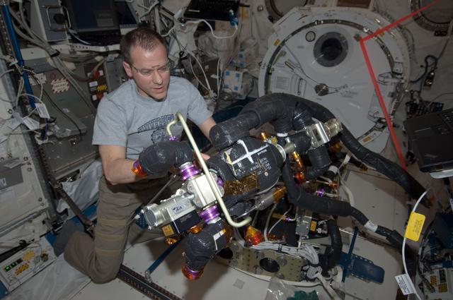NASA image: Marshburn performs maintenance on the CDRA in the JPM