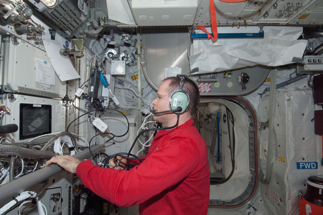 ISS034-E-067237 (13 March 2013) --- Inside the Columbus module on the International Space Station, Expedition 34 Commander Kevin Ford talks to students in Mt. Ousley, Australia during Expedition 34 Ham radio operations on March 13, 2013. He is reading questions that were uplinked by the students.