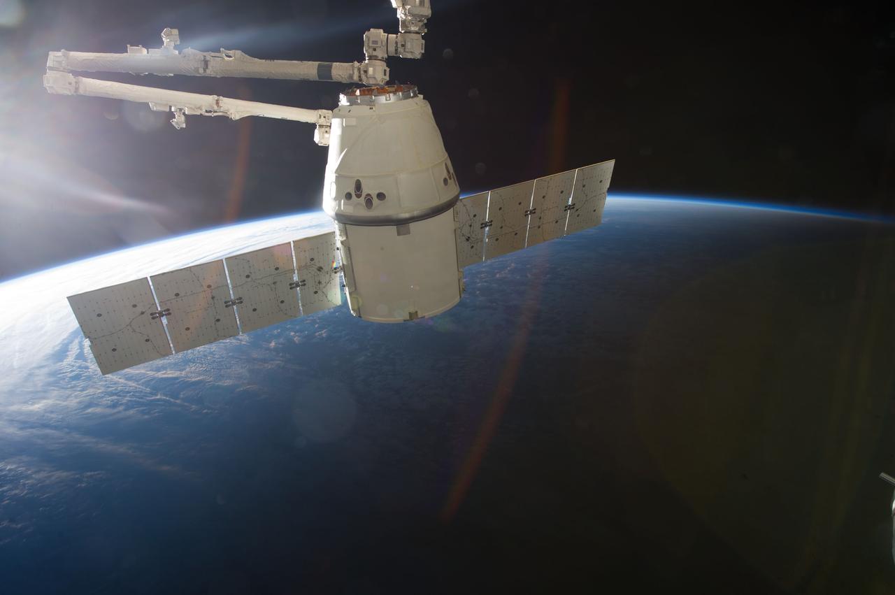 ISS035-E-008918 (26 March 2013) ---This image is one of a series of still photos documenting the process to release the SpaceX Dragon-2 spacecraft from the International Space Station on March 26.  The spacecraft, filled with experiments and old supplies, can be seen in the grasp of the Space Station Remote Manipulator System’s robot arm or CanadArm2 after it was undocked from the orbital outpost.  The Dragon was scheduled to make a landing in the Pacific Ocean, off the coast of California, later in the day.