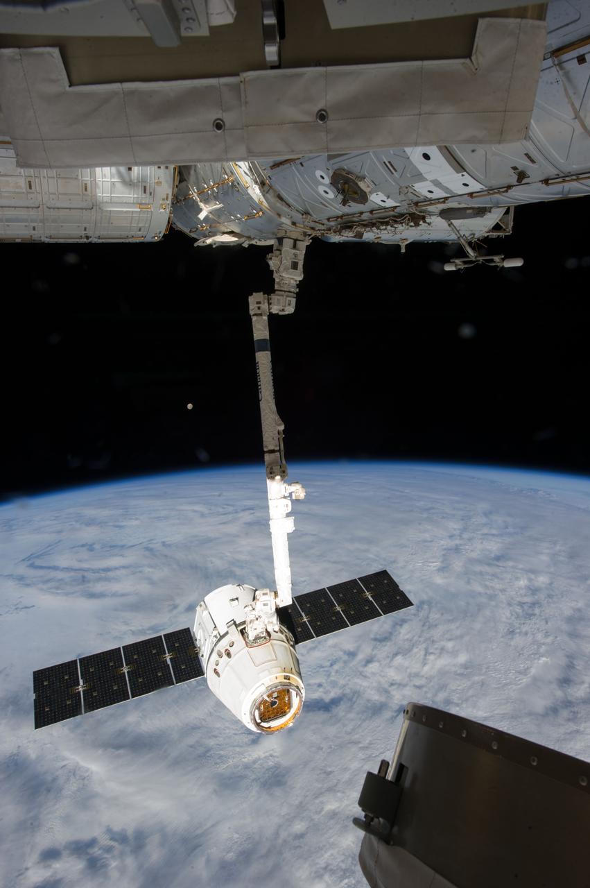 ISS035-E-008920 (26 March 2013) ---This image is one of a series of still photos documenting the process to release the SpaceX Dragon-2 spacecraft from the International Space Station on March 26.  The spacecraft, filled with experiments and old supplies, can be seen in the grasp of the Space Station Remote Manipulator System’s robot arm or CanadArm2 after it was undocked from the orbital outpost.  The Dragon was scheduled to make a landing in the Pacific Ocean, off the coast of California, later in the day.