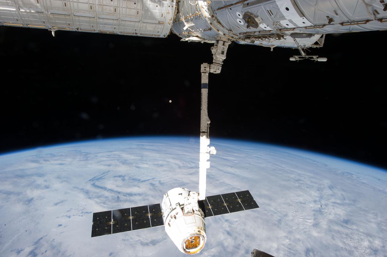 ISS035-E-008930 (26 March 2013) ---This image is one of a series of still photos documenting the process to release the SpaceX Dragon-2 spacecraft from the International Space Station on March 26.  The spacecraft, filled with experiments and old supplies, can be seen in the grasp of the Space Station Remote Manipulator System’s robot arm or CanadArm2 after it was undocked from the orbital outpost.  The Dragon was scheduled to make a landing in the Pacific Ocean, off the coast of California, later in the day.