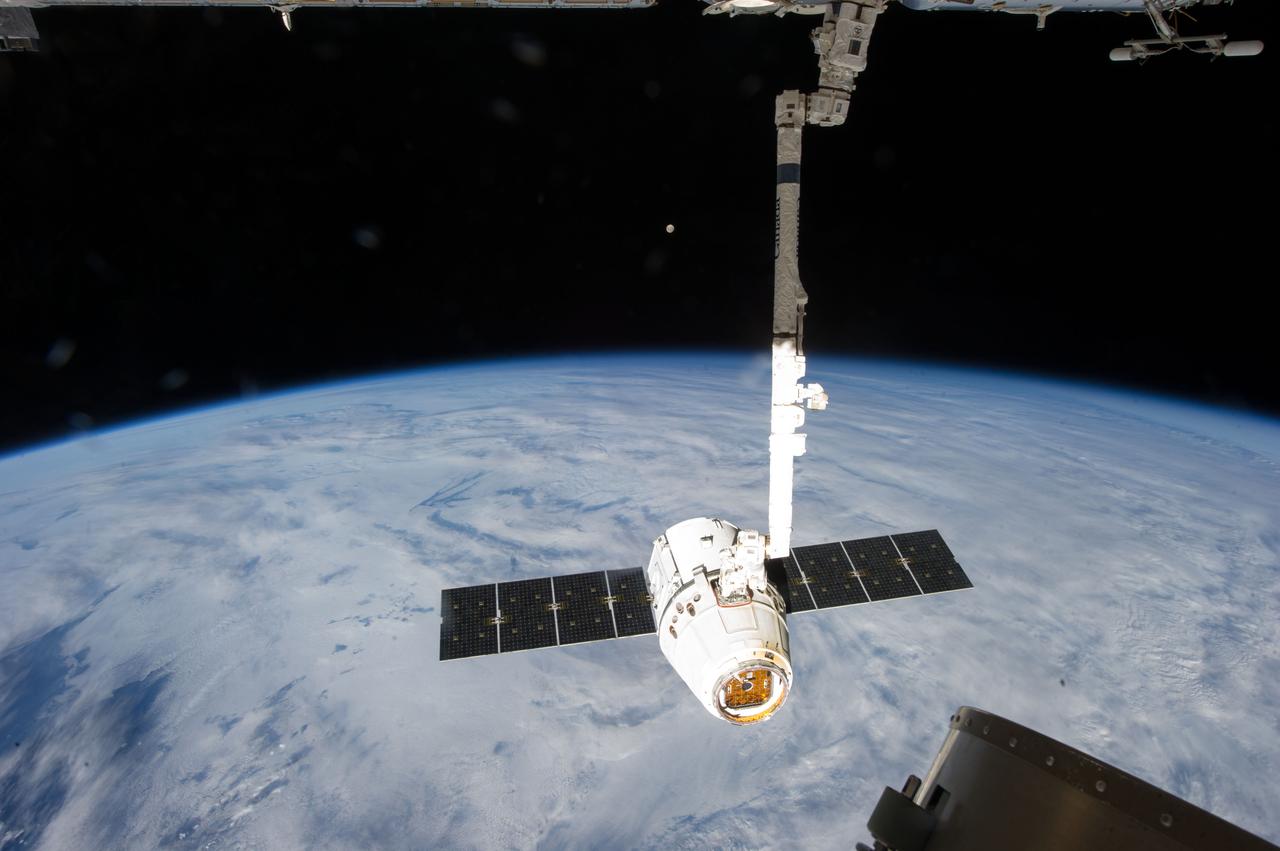 ISS035-E-008932 (26 March 2013) --- This image is one of a series of still photos documenting the process to release the SpaceX Dragon-2 spacecraft from the International Space Station on March 26.  The spacecraft, filled with experiments and old supplies, can be seen in the grasp of the Space Station Remote Manipulator System’s robot arm or CanadArm2 after it was undocked from the orbital outpost.  The Dragon was scheduled to make a landing in the Pacific Ocean, off the coast of California, later in the day.