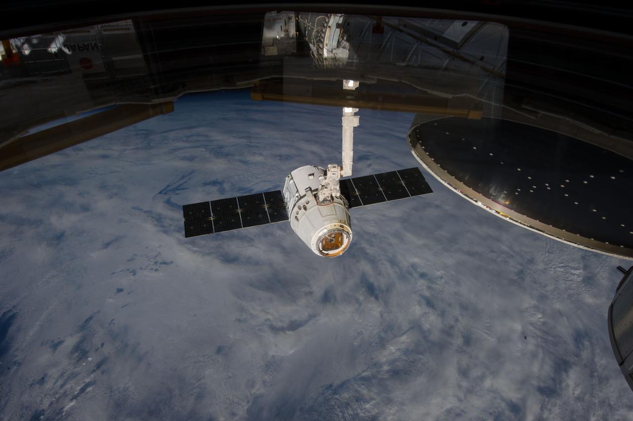 ISS035-E-008935 (26 March 2013) --- This image is one of a series of still photos documenting the process to release the SpaceX Dragon-2 spacecraft from the International Space Station on March 26.  The spacecraft, filled with experiments and old supplies, can be seen in the grasp of the Space Station Remote Manipulator System’s robot arm or CanadArm2 after it was undocked from the orbital outpost.  The Dragon was scheduled to make a landing in the Pacific Ocean, off the coast of California, later in the day.