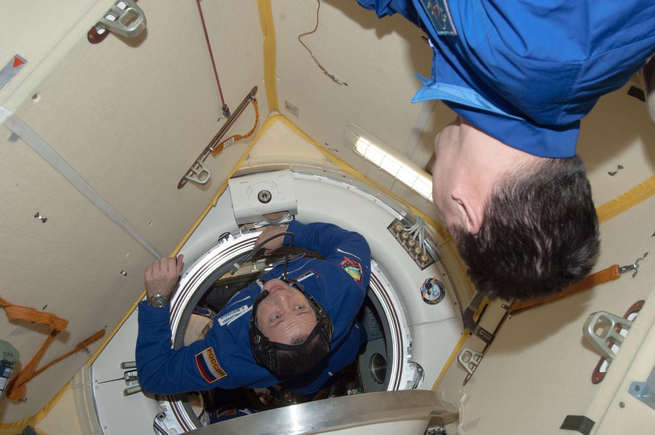 ISS035-E-010763 (29 March 2013) --- In this scene in the Poisk or Mini-Research Module 2 (MRM2), Russian cosmonaut Alexander Misurkin, Expedition 35 flight engineer,  floats toward   fellow cosmonaut and Expedition 35 Flight Engineer Roman Romanenko soon after the Soyuz TMA-08M docked with the International Space Station on March 29.