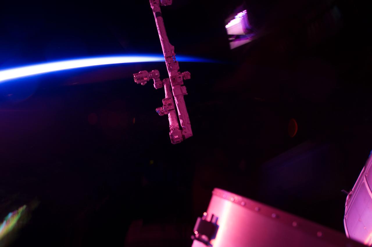 Earth airglow observation taken by the Expedition 35 crew aboard the ISS. The Canadarm2 Space Station Remote Manipulator System (SSRMS) and other portions of the ISS are in view.