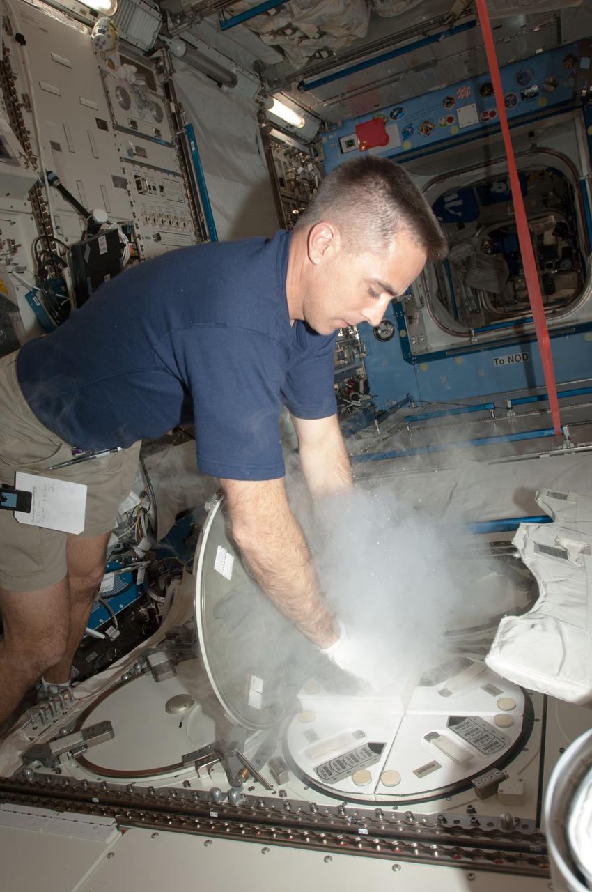 ISS035-E-012757 (1 April 2013) --- Expedition 35 Flight Engineer Chris Cassidy of NASA works with samples at the Minus Eighty-Degree Laboratory Freezer for the International Space Station (MELFI) in the Japan Aerospace Exploration Agency?s Kibo lab aboard the International Space Station.