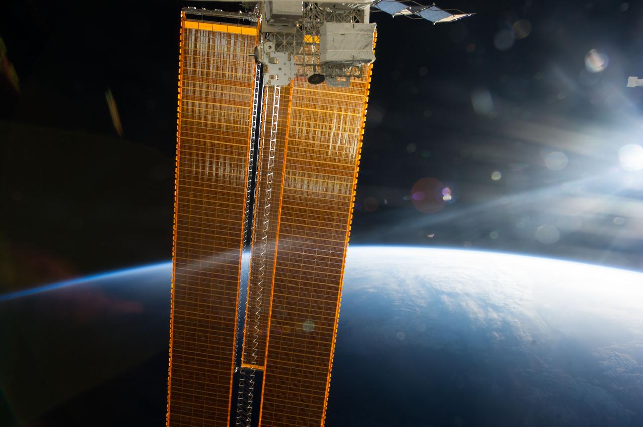 Earth observation taken by the Expedition 35 crew aboard the ISS. The terminator, glare from the rising Sun, and solar array wings (SAWs) are in view.