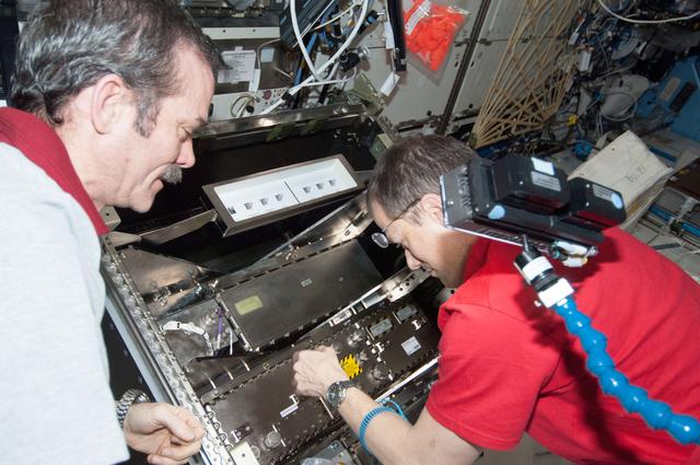 NASA image: Hadfield and Marshburn during HRCS Ku Comm Unit 2 Installation