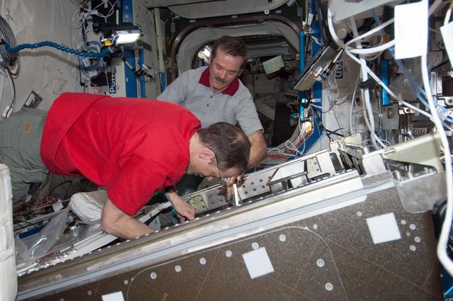 NASA image: Hadfield and Marshburn during HRCS Ku Comm Unit 2 Installation
