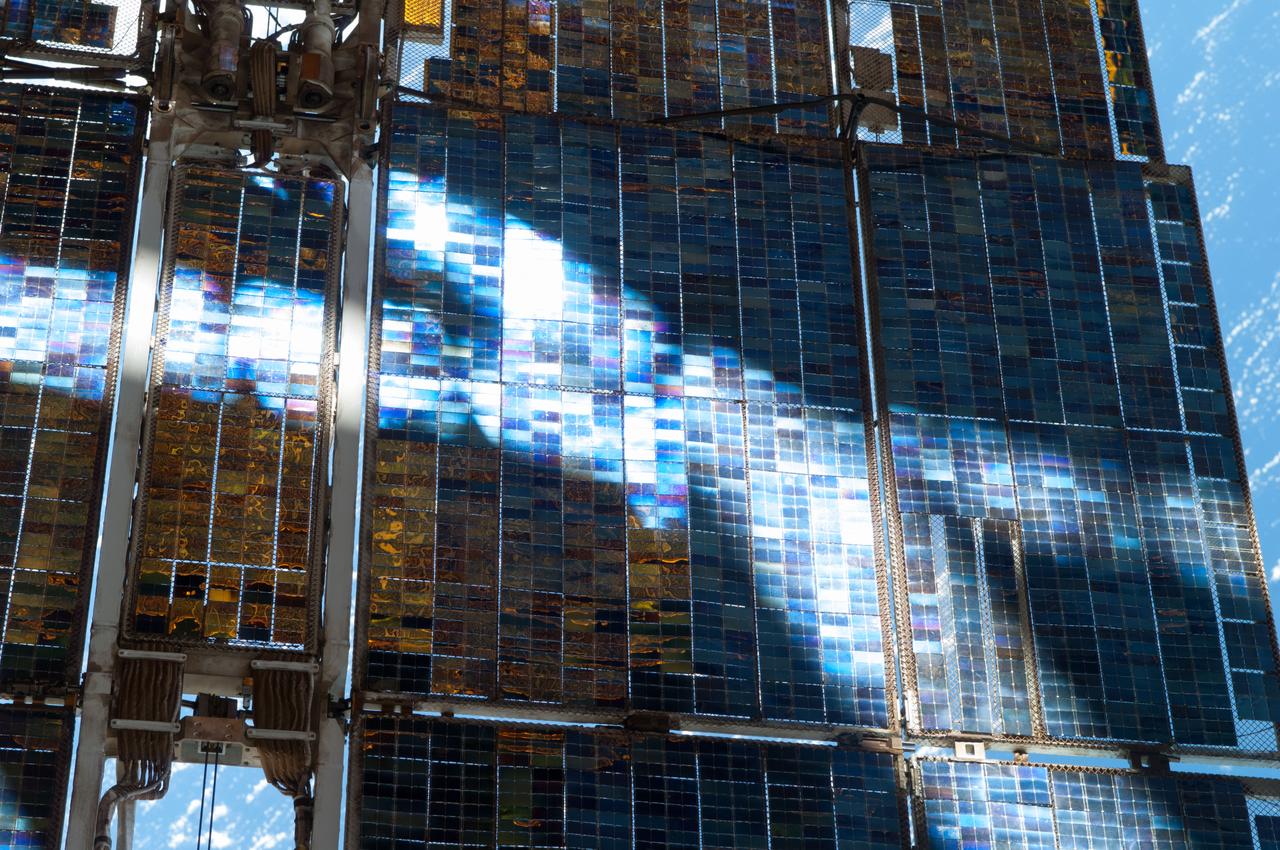 Survey view of a portion of a solar array on the Zvezda Service Module (SM) taken through a window in the Russian segment of the ISS during Expedition 35.