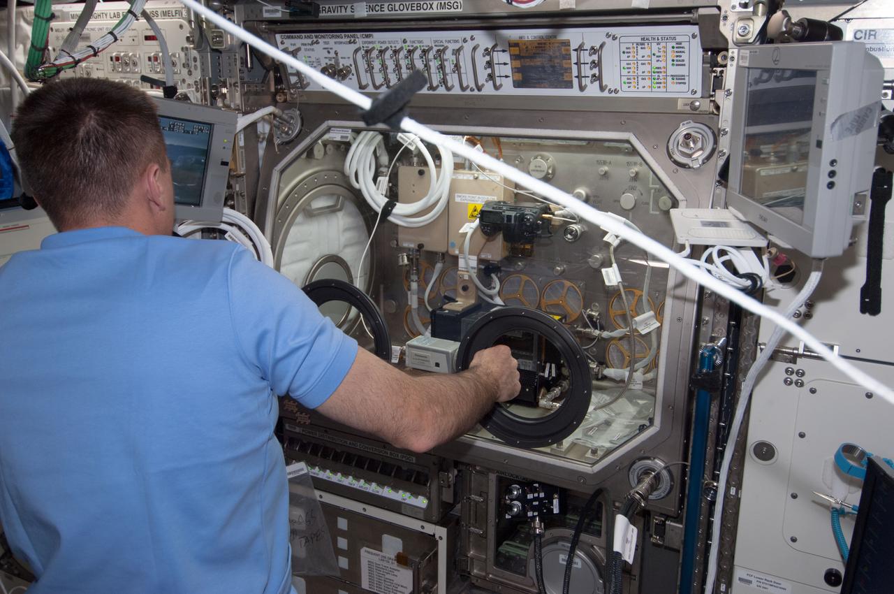 ISS035-E-015081 (5 April 2013) --- Astronaut Chris Cassidy, Expedition 35 flight engineer,  conducts a session of the Burning and Suppression of Solids (BASS) experiment onboard the Earth-orbiting International Space Station. Following a series of preparations,  Cassidy conducted a run of the experiment, which examined the burning and extinction characteristics of a wide variety of fuel samples in microgravity and will guide strategies for extinguishing fires in microgravity. BASS results contribute to the combustion computational models used in the design of fire detection and suppression systems in microgravity and on Earth.