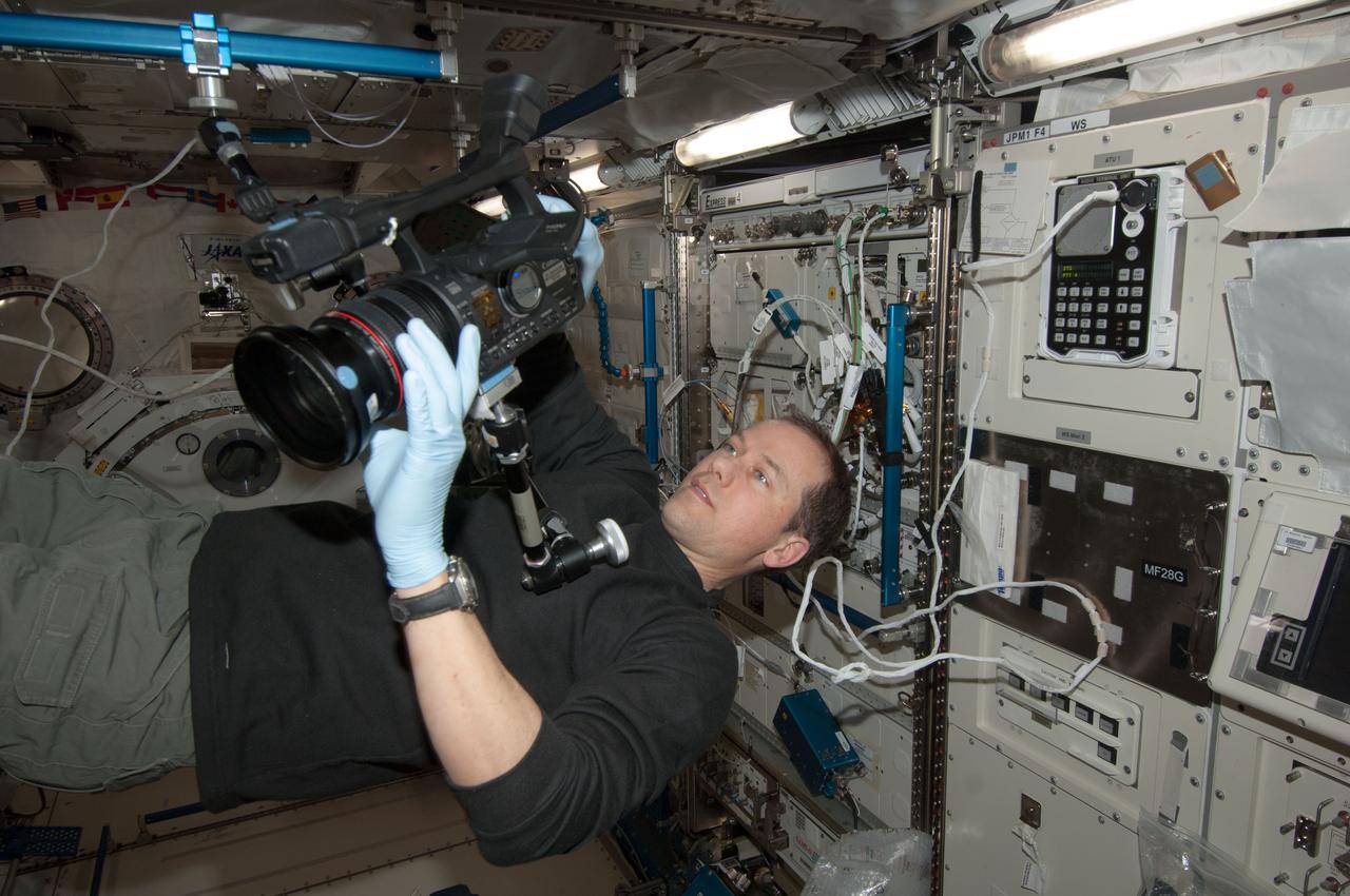 ISS035-E-016038 (4 April 2013) --- NASA astronaut Tom Marshburn records video with a camcorder in the Kibo module aboard the International Space Station.