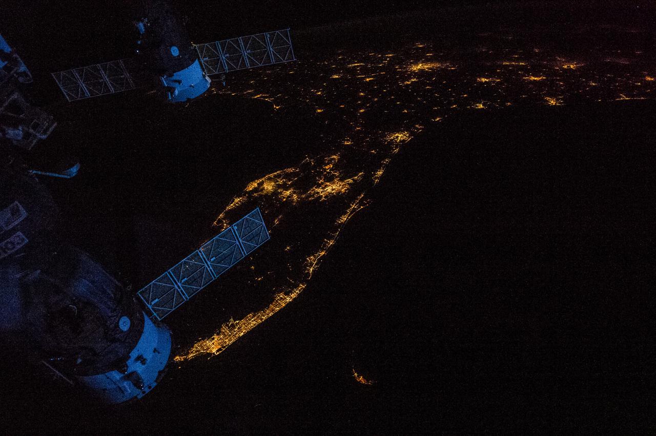 Earth observation taken by the Expedition 35 crew aboard the ISS. Night view of city lights and portions of the ISS.