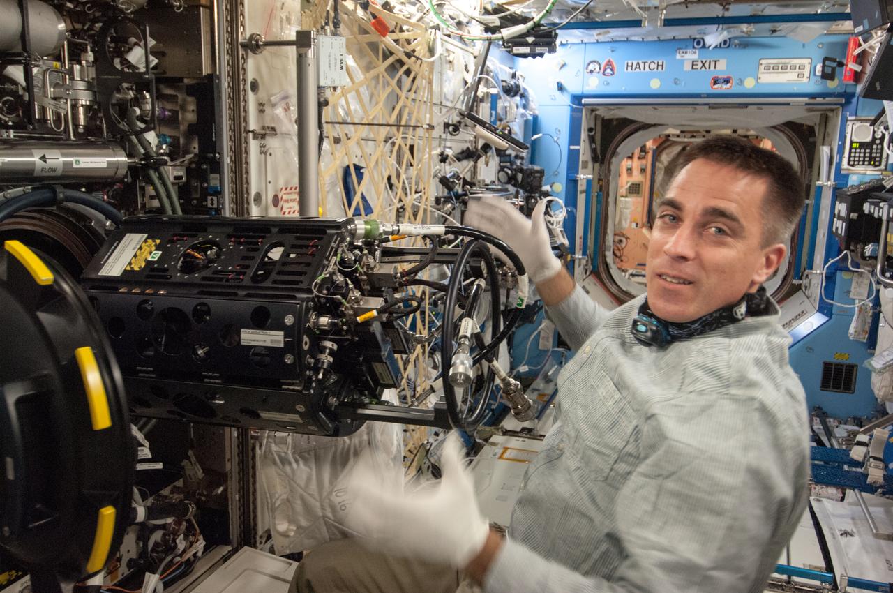 ISS035-E-017699 (10 April 2013) --- This is one of several photos documenting the  Multi-user Droplet Combustion Apparatus (MDCA) Fuel Reservoir replacement.  Here, Expedition 35 Flight Engineer Chris Cassidy removes and replaces one of the Fuel Reservoirs with the MDCA Chamber Insert Assembly (CIA) pulled partially out of the Combustion Chamber. The MDCA Fuel Reservoirs contain the liquid fuel used during droplet combustion experiments.   This reservoir change-out was in support of the FLame EXtinguishment (FLEX)-2 experiment, scheduled to be executed by ground controllers.