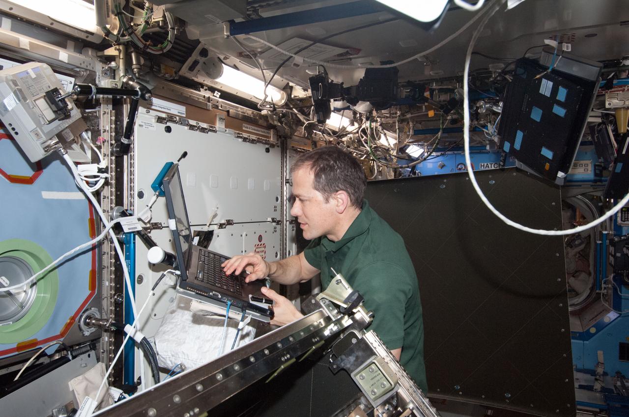 ISS035-E-018268 (11 April 2013) --- Expedition 35 Flight Engineer Tom Marshburn, NASA astronaut, installs the redundant Ku Communications 1 unit in Destiny to complete the refurbishment of the Ku system aboard the International Space Station. Expedition 35 Commander Chris Hadfield (out of frame), astronaut with the Canadian Space Agency, joined Marshburn for this work.