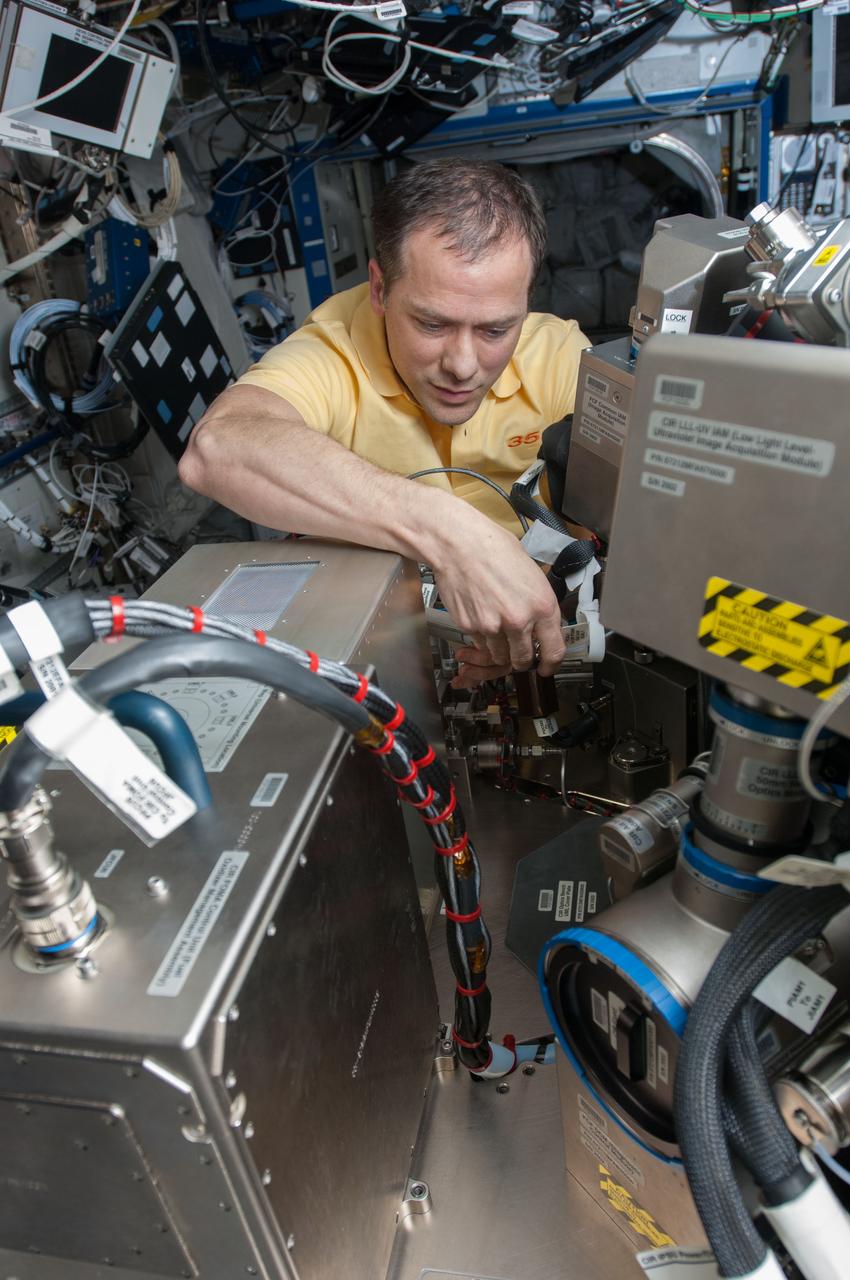 ISS035-E-020086 (15 April 2013) --- NASA astronaut Tom  Marshburn, Expedition 35 flight engineer, conducts routine maintenance of the Combustion Integration Rack?s Optic Bench in the U.S. lab Destiny aboard the Earth-orbiting Internatioanl Space Station.