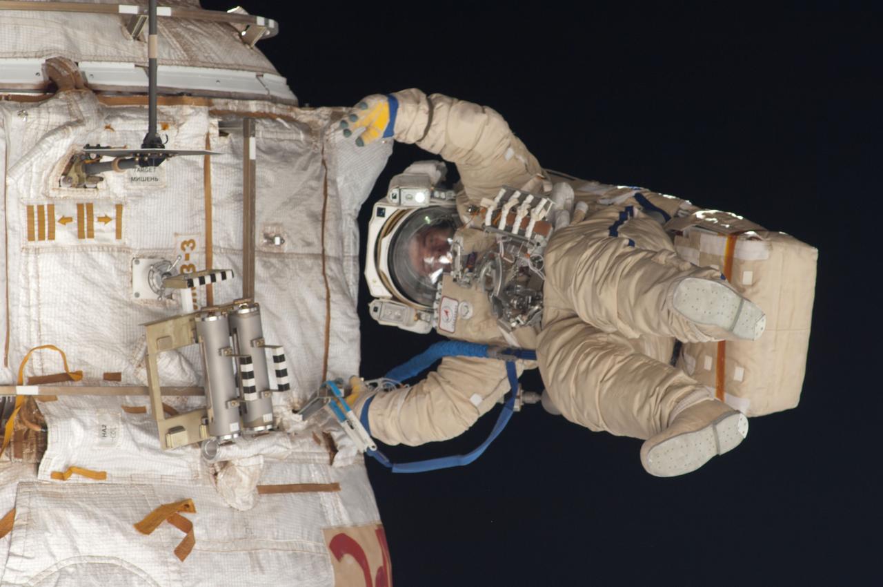 ISS035-E-023969 (19 April 2013) --- Expedition 35 Russian cosmonaut Roman Romanenko translates outside the International Space Station on April 19, 2013, during the first spacewalk of  the Expedition 35 mission. Romanenko and Pavel Vinogradov (out of frame) went on to spend about six hours upgrading the station?s exterior hardware.