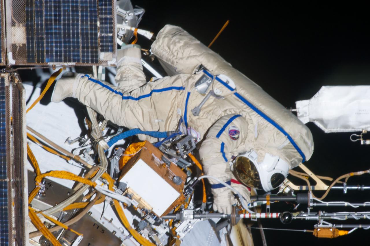 ISS035-E-027782 (19 April 2013) --- Expedition 35 Russian cosmonaut Pavel Vinogradov translates outside the International Space Station on April 19, 2013, during the first spacewalk of the Expedition 35 mission.  Vinogradov and Roman Romanenko (out of frame) went on to spend about six hours upgrading the station's exterior hardware.