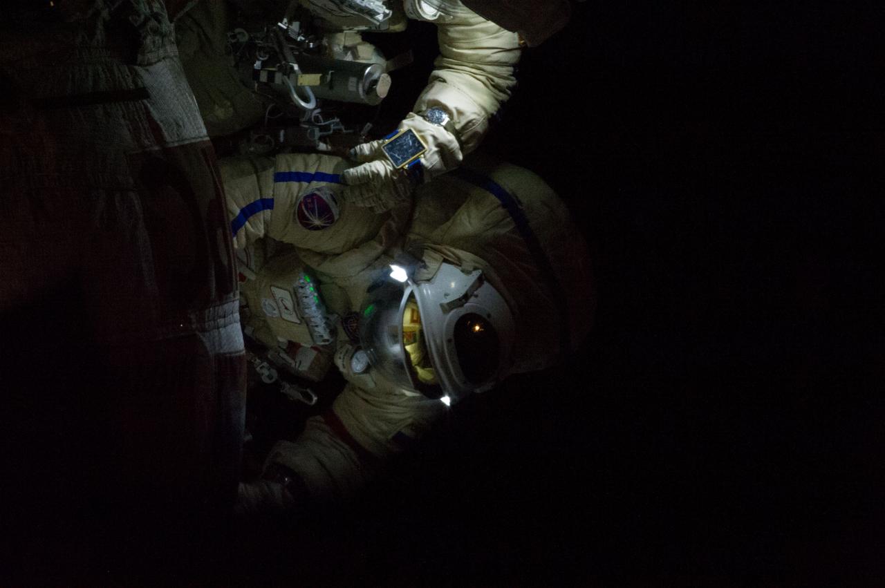 ISS035-E-027831 (19 April 2013) --- Surrounded by darkness, Expedition 35 Russian cosmonaut Pavel Vinogradov translates outside the International Space Station on April 19, 2013, during the first spacewalk of the Expedition 35 mission. Vinogradov and fellow cosmonaut Roman Romanenko (out of frame) went on to spend about six hours upgrading the station's exterior hardware.