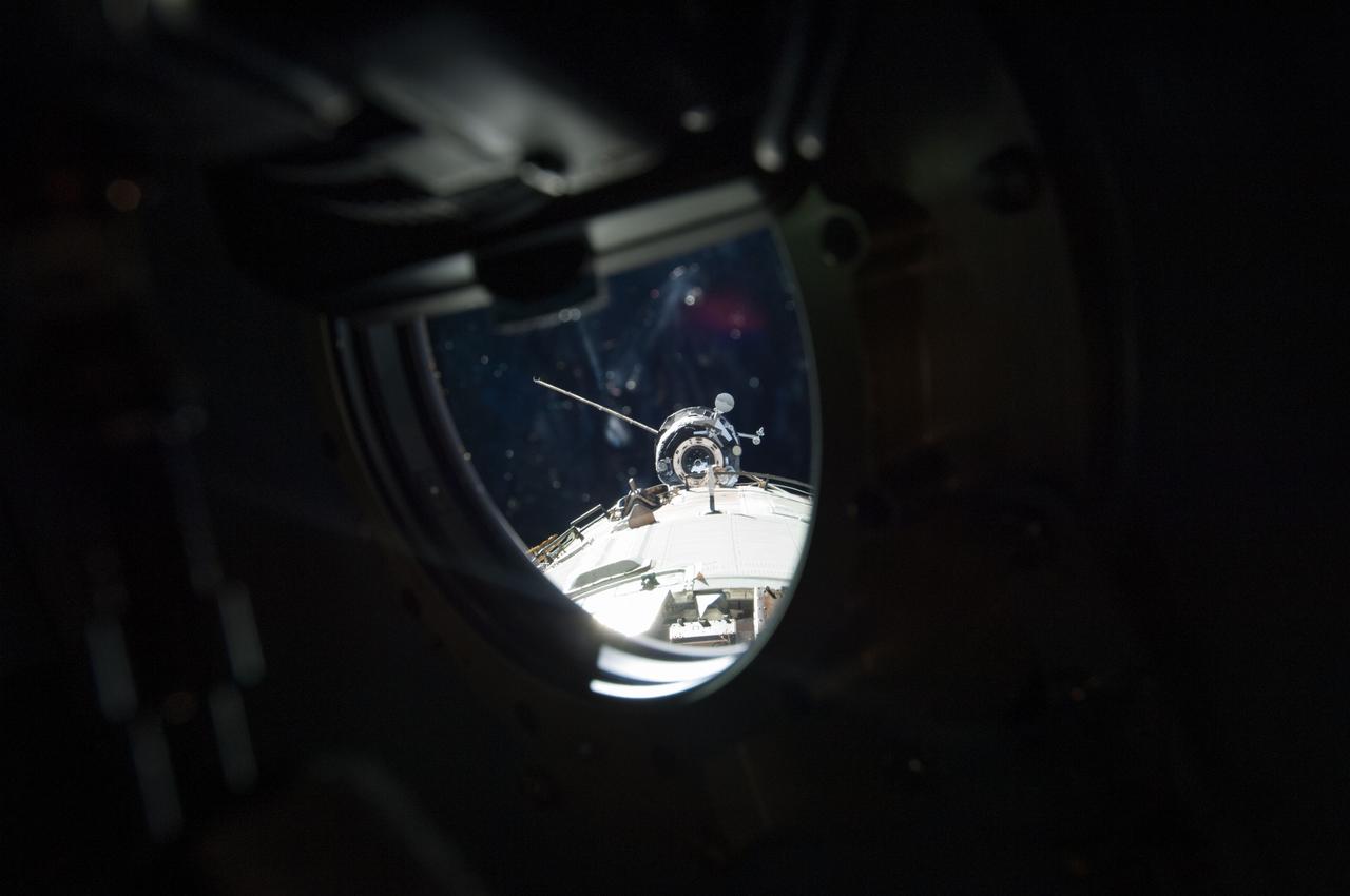ISS035-E-029729 (26 April 2013) --- As seen through one of the windows in the Zvezda Transfer Chamber (the aft section of the  service module), the Russian Progress 51 cargo craft approaches the International Space Station on April 26, 2013. The unmanned cargo vehicle minutes later successfully docked with the orbital outpost.