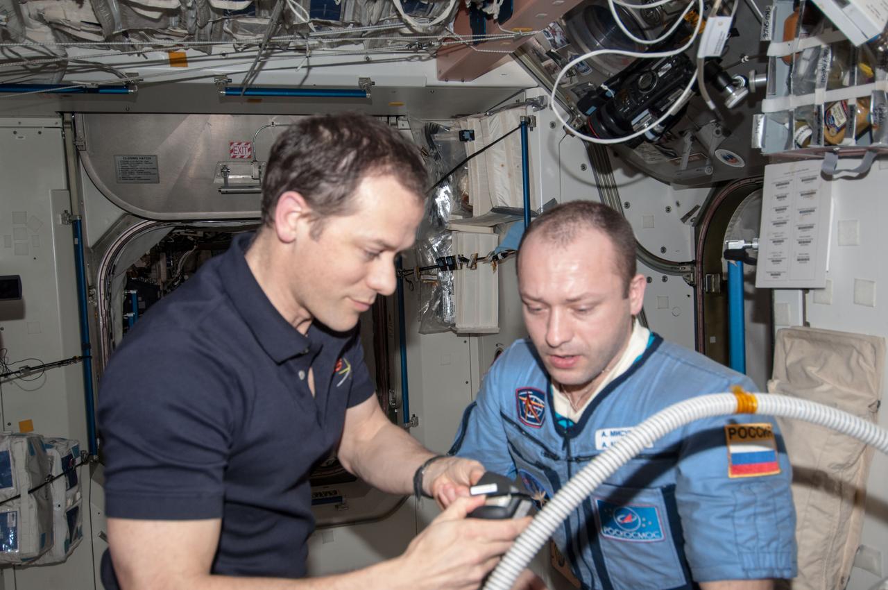 ISS035-E-030120 (28 April 2013) --- Most of the six Expedition 35 crew members got haircuts on April 28 in the Unity node of the Earth-orbiting International Space Station. Here, NASA astronaut Tom Marshburn prepares to trim the head of Russian cosmonaut Alexander Misurkin.