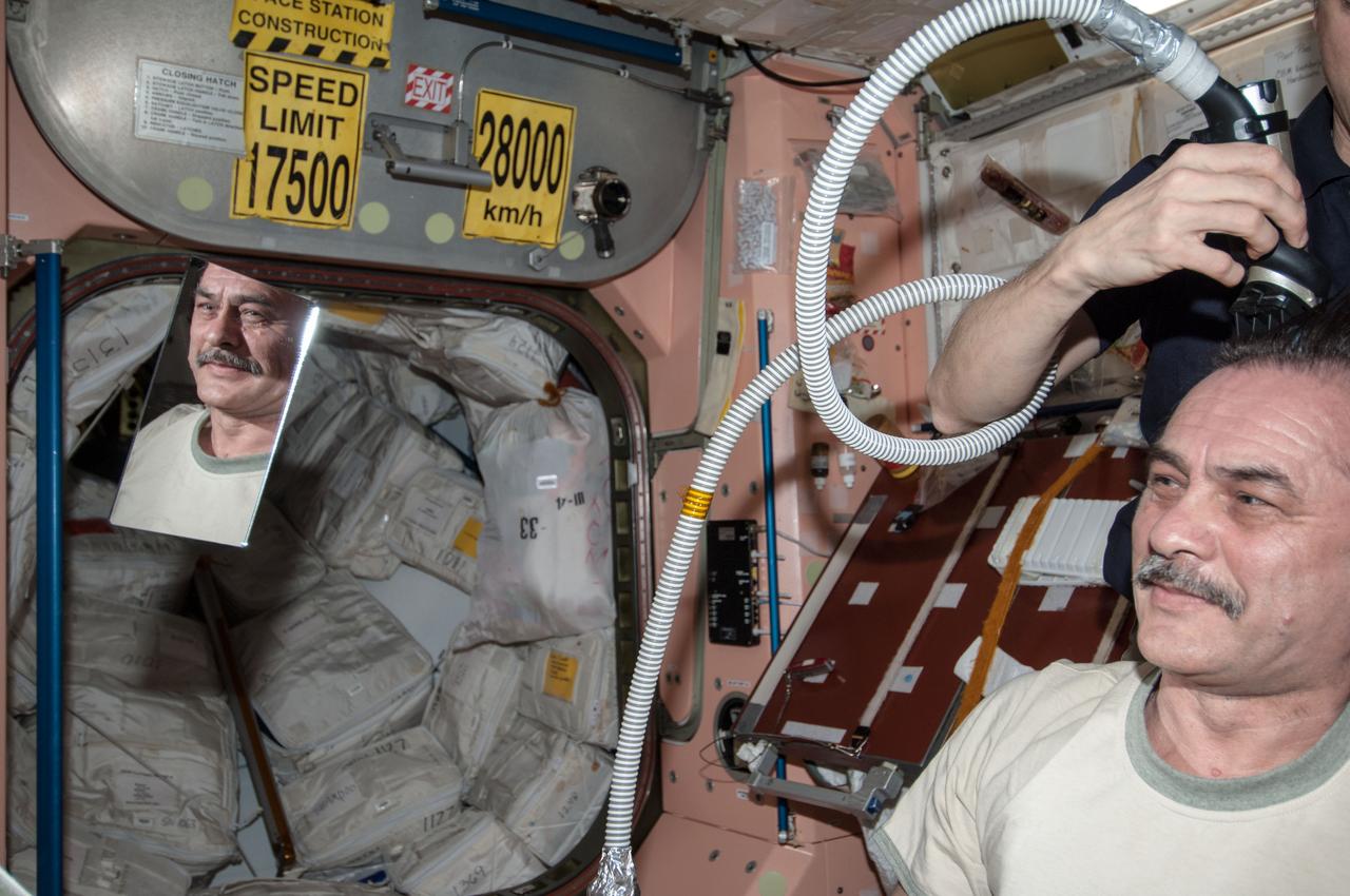 ISS035-E-030128 (28 April 2013) --- Most of the six Expedition 35 crew members got haircuts on April 28 in the Unity node of the Earth-orbiting International Space Station. Here, NASA astronaut Tom Marshburn trims the head of Russian cosmonaut Pavel Vinogradov.